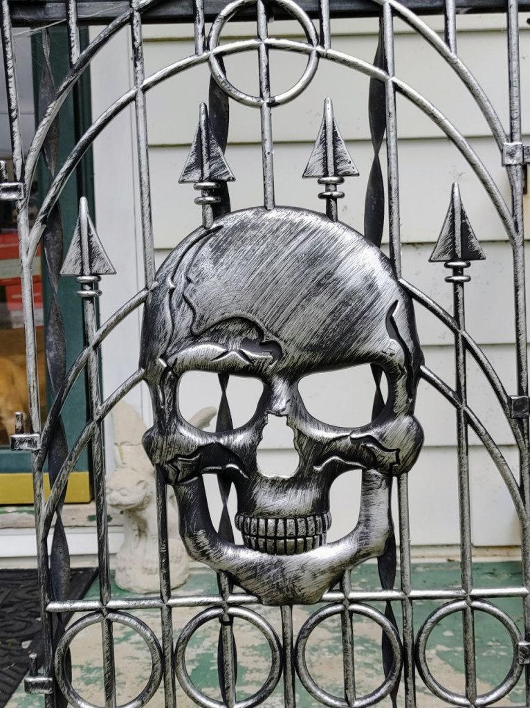 Fake wrought iron decor with silver skull.